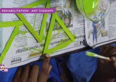A girl doing art and craft as part of art therapy rehabilitation for rescued girls